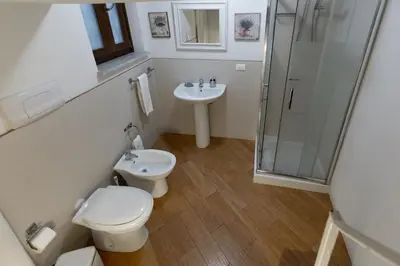 a bathroom with a toilet and a sink and a shower at GuestHost - Quattro Canti Charming Flat in Palermo