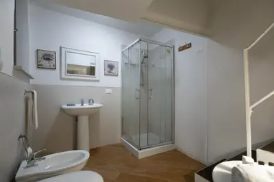 a bathroom with a shower and a toilet and a sink at GuestHost - Quattro Canti Charming Flat in Palermo