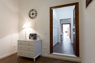 a mirror in a room with a dresser and a hallway at GuestHost - Quattro Canti Charming Flat in Palermo