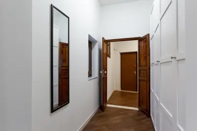 a hallway with a mirror and a door at GuestHost - Quattro Canti Charming Flat in Palermo