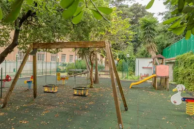 a playground with a swing set in a park at Casa per Ferie Don Orione Palermo in Palermo