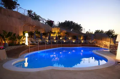 a large swimming pool in front of a resort at Villa Vittoria Hotel in Alcamo