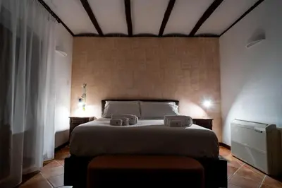 a bedroom with a bed with two towels on it at Villa Vittoria Hotel in Alcamo