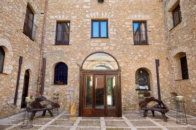 a stone building with a door in front of it at Villa Vittoria Hotel in Alcamo