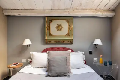 a bedroom with a bed with a picture on the wall at Il Giardino di Ballarò Boutique B&B in Palermo