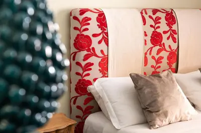 a white couch with red and white curtains and a pillow at Il Giardino di Ballarò Boutique B&B in Palermo