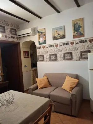 a living room with a couch and a table at Loft CASA PROFESSA 1 in Palermo
