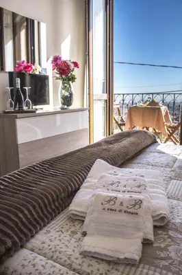 a bed with towels on it in a room at A casa di Simona in Monreale
