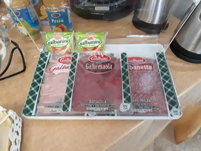 three packages of meat on top of a counter at A casa di Simona in Monreale