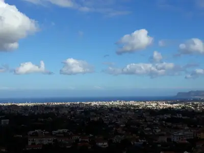 a view of a city with clouds in the sky at A casa di Simona in Monreale
