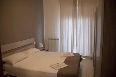 a bedroom with a bed with two towels on it at La Casita 24 in Palermo