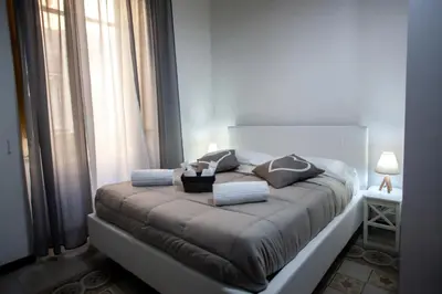 a bed in a room with a large window at ALBA DEL CAPO in Palermo