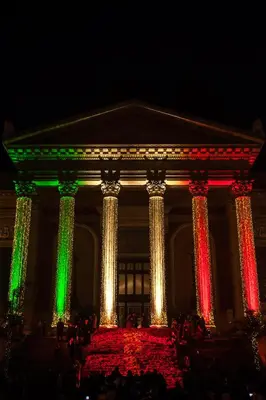 a building with colorful lights on it at night at ALBA DEL CAPO in Palermo