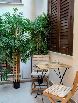 a table and two chairs and a table and plants at Porta di Castro Hotel & SPA in Palermo