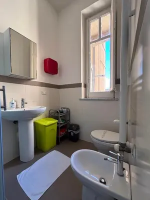 a bathroom with a sink and a toilet and a window at Mamamia #Teatro Massimo in Palermo