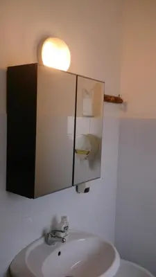 a room with two beds and a desk and a window at MillePini in Calatafimi