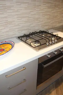 a kitchen with a stove and a plate on a counter at Mamiani Suite in Castellammare del Golfo