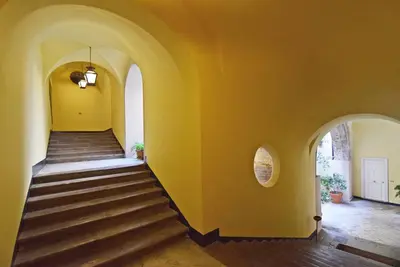 a staircase in a house with yellow walls at Casa Santa Sofia in Palermo