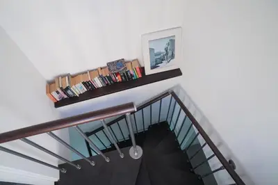 a row of books sitting on a shelf at Seaside 3 Bedroom Villa with 2 Terrace and private parking - Villa Porta Azzurro in Termini Imerese