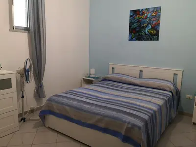 a bedroom with a bed and a painting on the wall at Short Lets Vacanze 