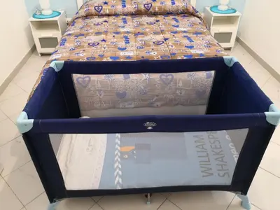 a bed with a blue frame in a room at Short Lets Vacanze 