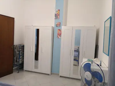 a room with two white cabinets and a fan at Short Lets Vacanze 