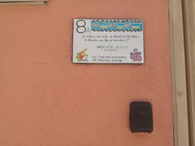 a sign on a pink door with a sign on it at Short Lets Vacanze 