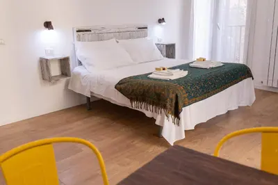 a bedroom with a bed with a table and chairs at Ai Tre Mercati in Palermo