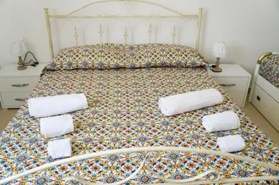 a bedroom with a bed with towels on it at Appartamenti Duchessa in Castellammare del Golfo
