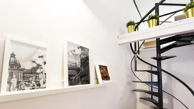 a staircase in a room with pictures on the wall at SpAsimoH-1 in Palermo