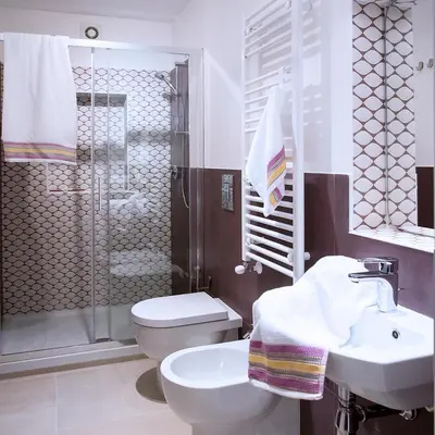 a bathroom with a toilet and a sink and a shower at SpAsimoH-2 in Palermo