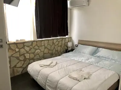 a bedroom with a bed with towels on it at Dolce Vita casa vacanze in Carini
