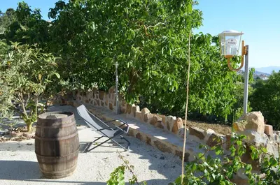 a bench sitting next to a barrel and a street light at Villa della Mimosa in Alia