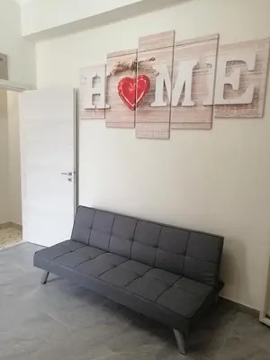 a couch against a wall with a heart and the word marrow at Casagioiosa18 in Palermo