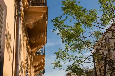 a view of a building and a tree at casa mo room and suite in Palermo