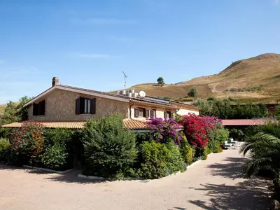 a house with a bunch of plants in front of it at Villa in Alia with Pool & Olive Views in Alia
