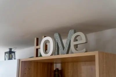 a sign that says love on top of a cabinet at A casa di Antonietta in Palermo
