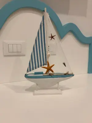 a toy sail boat with a starfish on a wall at EXCLUSIVE HOME in Castellammare del Golfo