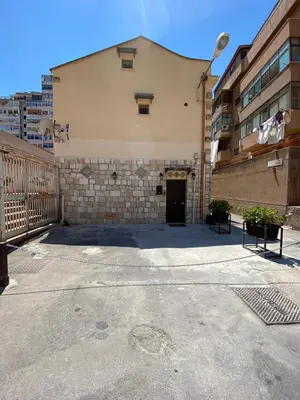 an empty parking lot in front of a building at La casetta del vicoletto in Palermo