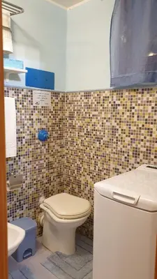 a bathroom with a toilet and a sink at La casetta del vicoletto in Palermo