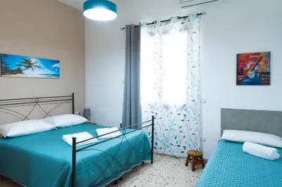 a bedroom with two beds and a window at Villa con piscina Alcamo Marina in Alcamo