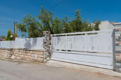 a white fence with a white gate at Villa con piscina Alcamo Marina in Alcamo
