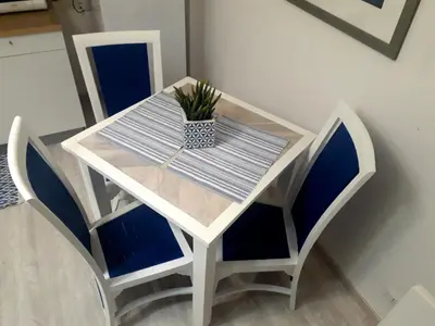 a white table and chairs with a potted plant on it at MiKlod Apartments in Palermo
