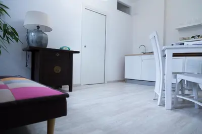 a living room with a table and a kitchen at MiKlod Apartments in Palermo