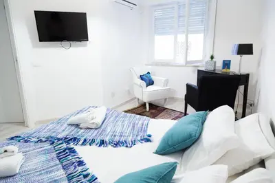 a bedroom with a bed and a tv on the wall at MiKlod Apartments in Palermo