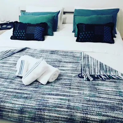 a bed with two white plates and utensils on it at MiKlod Apartments in Palermo