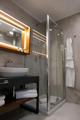 a bathroom with a glass shower and a sink at Palazzo Sovrana Serviced Luxury Apartments in Palermo