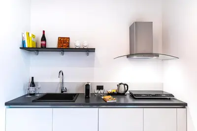 a kitchen with a sink and a counter top at Palazzo Sovrana Serviced Luxury Apartments in Palermo