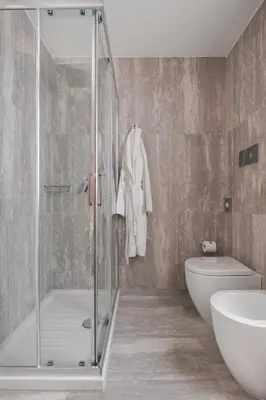 a bathroom with a shower and a toilet and a sink at Palazzo Sovrana Serviced Luxury Apartments in Palermo