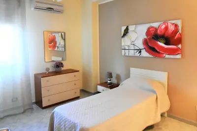 a bedroom with a bed and a painting on the wall at Bed and Breakfast Il Girasole in Mondello